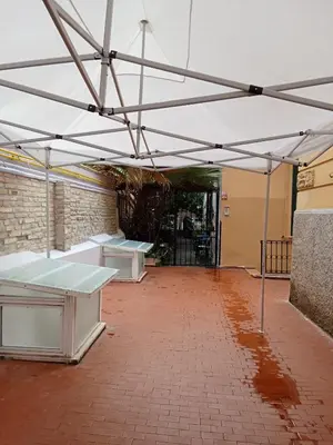 an empty room with two tables in a building at L'attico di Val. in Rome