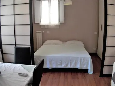 a bedroom with a white bed and a mirror at L'attico di Val. in Rome