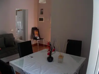 a living room with a white table and chairs at L'attico di Val. in Rome