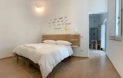 a bedroom with a large bed with white sheets at Santa Maria Suites in Rome