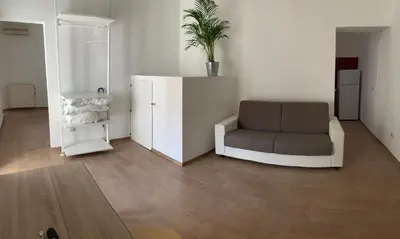 a living room with a chair and a plant at Santa Maria Suites in Rome