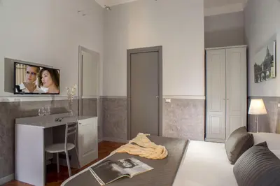 a living room with a table and a tv on the wall at Domus Liberius - Rome in Rome