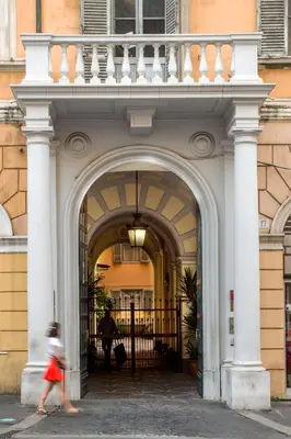 a girl walking through an archway in a building at Domus Liberius - Rome in Rome