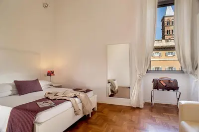 a bedroom with a bed and a large window at Domus Liberius - Rome in Rome