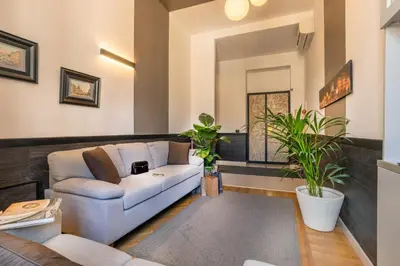a living room with a couch and some plants at Domus Liberius - Rome in Rome