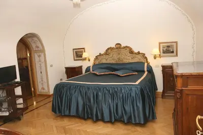 a bedroom with a bed with a blue comforter at Navona Gallery Suites in Rome
