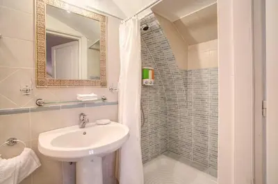 a bathroom with a sink and a shower at Navona Gallery Suites in Rome