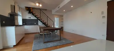 a kitchen with a table and a staircase in a house at Guesthouse Vassallo Due in Rome