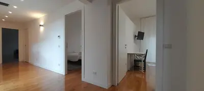 a room with a hallway with a table and a bed at Guesthouse Vassallo Due in Rome