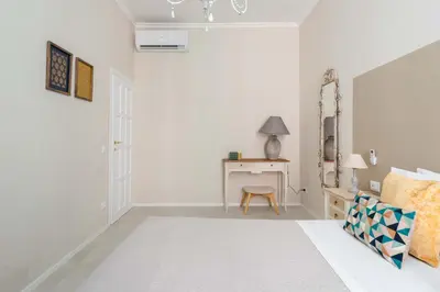 a white bedroom with a bed and a desk at SuityRHome RioneMonti54 in Rome