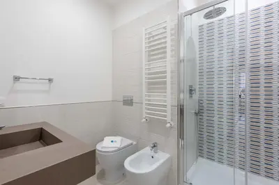 a bathroom with a shower and a toilet and a sink at SuityRHome RioneMonti54 in Rome