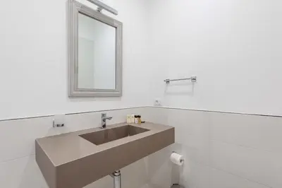 a bathroom with a sink and a mirror at SuityRHome RioneMonti54 in Rome