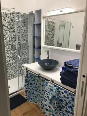 a bathroom with a sink and a shower at the blu and green apartment in Rome