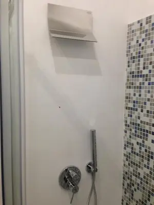 a bathroom with a white door with a shower at the blu and green apartment in Rome