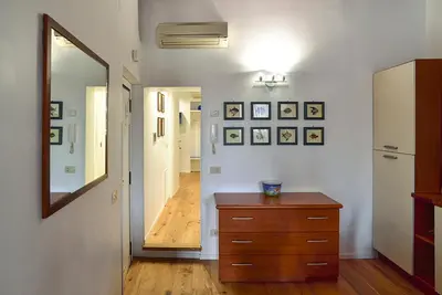 a room with a dresser and a hallway with a mirror at the blu and green apartment in Rome