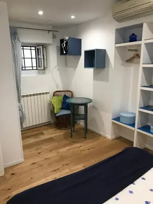 a living room with a table and a chair at the blu and green apartment in Rome