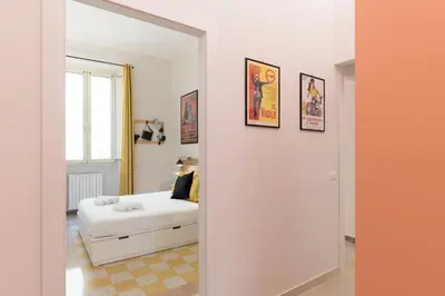 a living room with a white couch and a mirror at Casa Fellini - Charme Holidays in Rome