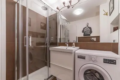a bathroom with a washing machine and a sink at Casa Fellini - Charme Holidays in Rome