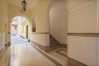 an empty hallway with stairs and an archway at Casa Fellini - Charme Holidays in Rome