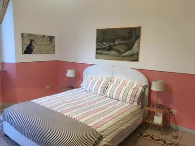 a room with a desk with a chair and a television at La Casa di Silvestro in Rome