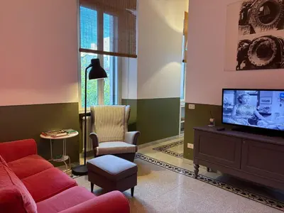a living room with a red couch and a table at La Casa di Silvestro in Rome