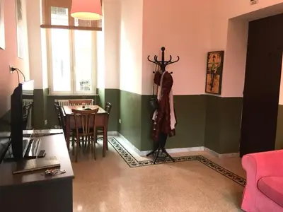 a living room with a flat screen tv and a table at La Casa di Silvestro in Rome