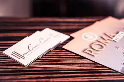 a table with two wedding cards on it at Maison Candia Luxury House in Rome