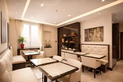 a dining room with tables and chairs in a room at Maison Candia Luxury House in Rome