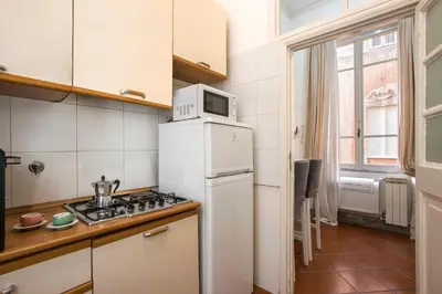 a kitchen with a white refrigerator and a microwave at Casa Coronari Holidays in Rome