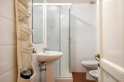 a bathroom with a sink and a toilet and a shower at Casa Coronari Holidays in Rome