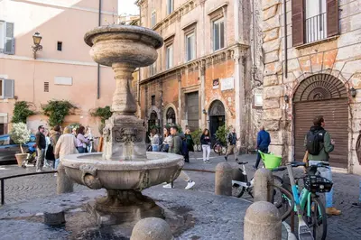 a fountain in the middle of a street in a city at Casa Coronari Holidays in Rome