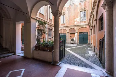 an empty alley in an old building with plants at Casa Coronari Holidays in Rome