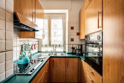 a kitchen with green counter tops and wooden cabinets at Sunrise Apartment in Rome