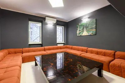 a living room with a orange couch and a table at Orso Apartment in Rome