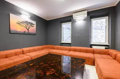 a living room with a couch and a glass table at Orso Apartment in Rome