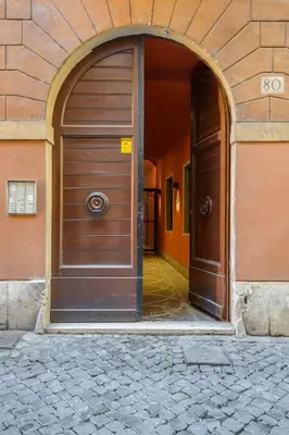 an entrance to a building with a large wooden door at Orso Apartment in Rome