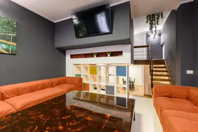 a living room with a couch and a fish tank in the floor at Orso Apartment in Rome