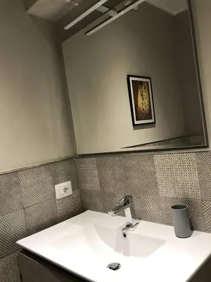 a bathroom with a sink and a large mirror at Giuly'S House Cozy & Comfy Apartment in Rome ....Real Rome !!! in Rome