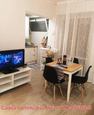 a living room with a dining table and a television at Giuly'S House Cozy & Comfy Apartment in Rome ....Real Rome !!! in Rome