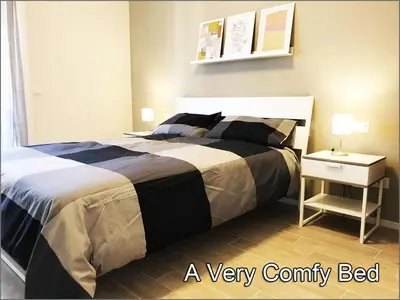a bedroom with a neatly made bed and a side table at Giuly'S House Cozy & Comfy Apartment in Rome ....Real Rome !!! in Rome