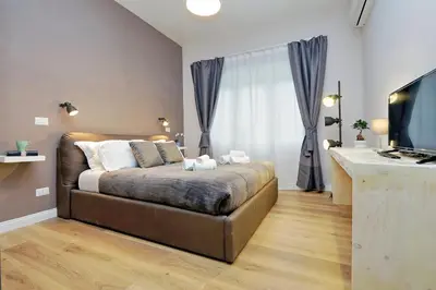 a bedroom with a bed and a large window at TERRACED APARTMENT - Metro to Vatican & center in Rome