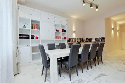 a dining room with a white table and chairs at TERRACED APARTMENT - Metro to Vatican & center in Rome