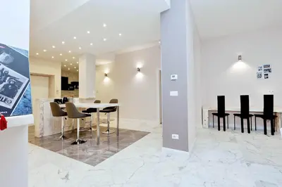 a dining room with a table and black chairs at TERRACED APARTMENT - Metro to Vatican & center in Rome
