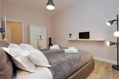 a bedroom with a large bed with white pillows at TERRACED APARTMENT - Metro to Vatican & center in Rome
