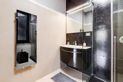a bathroom with a sink and a shower at EMERALD Luxury Suite Apartment in Rome
