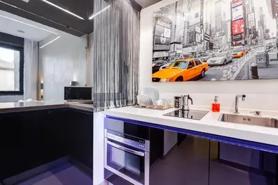 a kitchen with a sink and a yellow car on the wall at EMERALD Luxury Suite Apartment in Rome