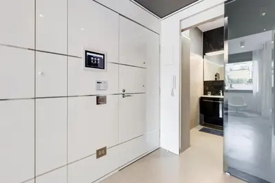 a white kitchen with white walls and a refrigerator at EMERALD Luxury Suite Apartment in Rome