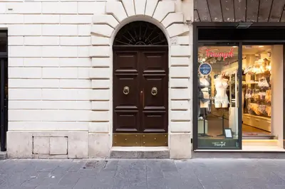 a store front with a black door on a building at EMERALD Luxury Suite Apartment in Rome
