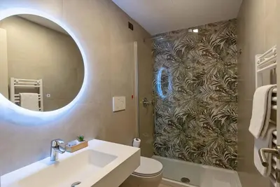 a bathroom with a sink and a shower with a mirror at Hotel Paba in Rome