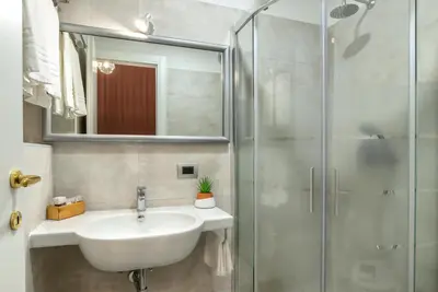 a bathroom with a sink and a shower at Hotel Paba in Rome